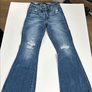 Buckle Flare Jeans in Distressed Blue